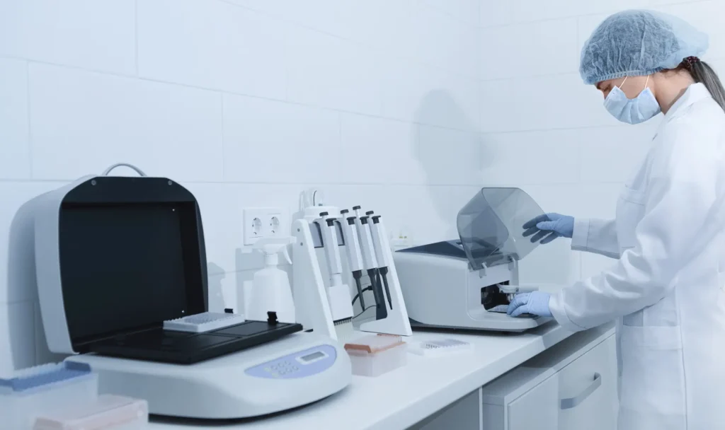 young woman working in modern laboratory and using       utc  e x