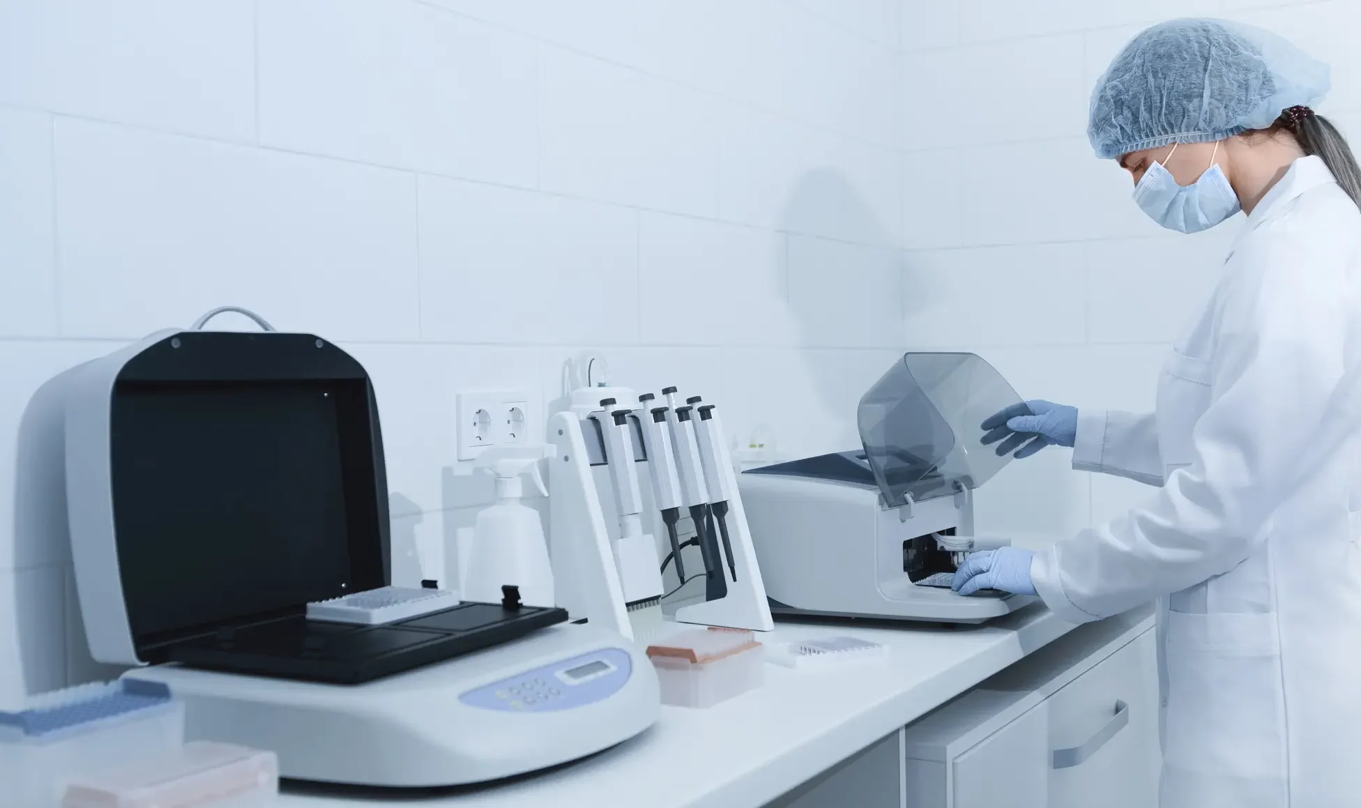 young woman working in modern laboratory and using       utc  e